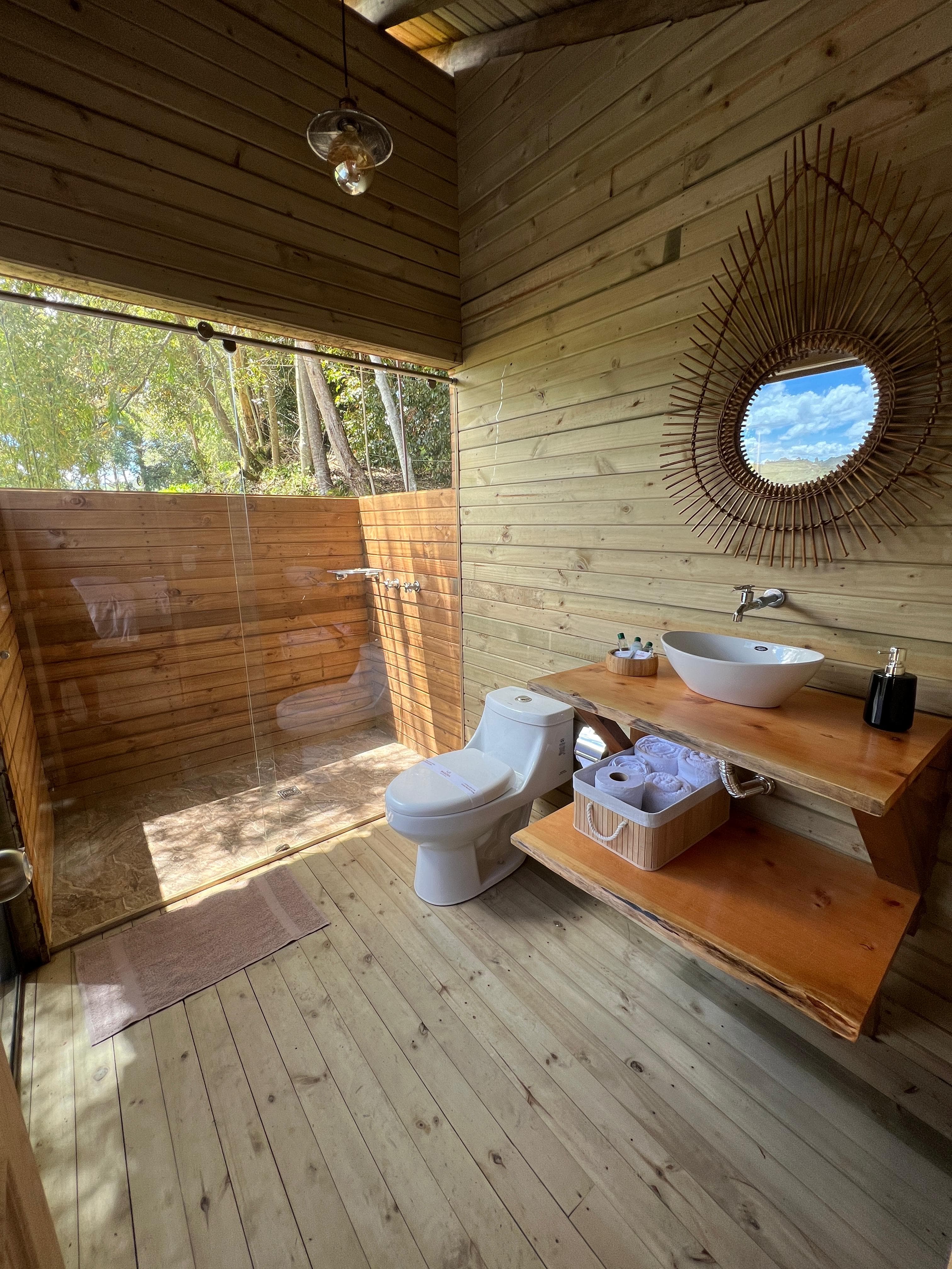 Baño con ducha, lavamanos y espejo
